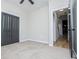 Spacious bedroom with plush carpet, closet with dark doors, and adjoining room for added space at 90 Ayers Rd, Bowdon, GA 30108