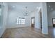 Bright dining room with hardwood floors, modern chandelier, and large windows at 90 Ayers Rd, Bowdon, GA 30108
