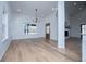 Open-concept dining room with hardwood floors and modern chandelier near living area at 90 Ayers Rd, Bowdon, GA 30108