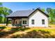 Exterior view of this modern farmhouse highlighting the white siding and black trim at 90 Ayers Rd, Bowdon, GA 30108