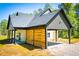 Exterior view featuring covered parking with a wood accent wall and dark trim finishes at 90 Ayers Rd, Bowdon, GA 30108