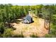 Rear aerial view of the home highlighting black roof, white exterior and natural landscape surrounding the home at 90 Ayers Rd, Bowdon, GA 30108