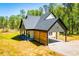 Exterior view of craftsman style home featuring covered parking and natural landscape at 90 Ayers Rd, Bowdon, GA 30108