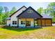 Charming home with modern siding and large windows at 90 Ayers Rd, Bowdon, GA 30108