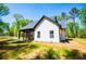 Exterior view of a charming white farmhouse style home with covered patio space at 90 Ayers Rd, Bowdon, GA 30108