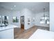 Bright dining area boasts hardwood floors, a modern light fixture and plenty of natural light at 90 Ayers Rd, Bowdon, GA 30108