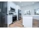 Kitchen boasts stainless steel appliances, white cabinets, and a bright center island at 90 Ayers Rd, Bowdon, GA 30108