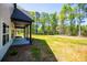 Covered patio with view of grassy backyard at 90 Ayers Rd, Bowdon, GA 30108
