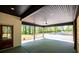 Covered porch with ceiling fan provides outdoor living space, seamlessly connecting interior and exterior at 90 Ayers Rd, Bowdon, GA 30108