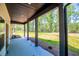 View of an expansive covered patio overlooking lush greenery, offering a serene outdoor retreat at 90 Ayers Rd, Bowdon, GA 30108