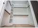 Bright walk-in closet with white shelving, ample space, and modern black rods for hanging clothes at 90 Ayers Rd, Bowdon, GA 30108