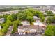 Aerial view of the townhome community surrounded by trees and parking, with a trainyard in the background at 1516 Howell Mill Nw Rd # 16, Atlanta, GA 30318