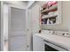 Neat laundry room with washer, dryer, shelving, and ironing board behind a door at 1516 Howell Mill Nw Rd # 16, Atlanta, GA 30318