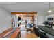 An open-concept living space with wood beam, fireplace, and dining area at 1516 Howell Mill Nw Rd # 16, Atlanta, GA 30318