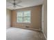 This spacious bedroom features neutral walls, carpet flooring, and a ceiling fan at 1744 Cum Laude Way, Lawrenceville, GA 30044