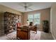 Bedroom featuring an industrial style desk, decor, and a large window at 1744 Cum Laude Way, Lawrenceville, GA 30044