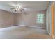Bedroom with ceiling fan, window and a doorway to the adjacent room at 1744 Cum Laude Way, Lawrenceville, GA 30044