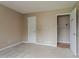 This bedroom features neutral walls, carpet flooring, and interior doors at 1744 Cum Laude Way, Lawrenceville, GA 30044