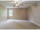 Bedroom features a ceiling fan, window to the outside, and carpeting at 1744 Cum Laude Way, Lawrenceville, GA 30044