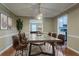 Elegant dining room featuring a large table, stylish decor, and hardwood floors at 1744 Cum Laude Way, Lawrenceville, GA 30044