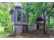 View of the back of the home with a partially visible porch and basement access at 1744 Cum Laude Way, Lawrenceville, GA 30044