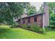 Lovely home exterior with brick and landscaping, red shutters, and chimney at 1744 Cum Laude Way, Lawrenceville, GA 30044