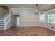 Bright kitchen area with tile floors and views of the stairway and outdoor scenery at 1744 Cum Laude Way, Lawrenceville, GA 30044