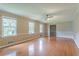 Bright living room with hardwood floors, large windows, and neutral wall colors at 1744 Cum Laude Way, Lawrenceville, GA 30044