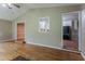 Open living room area with hardwood floors and view to the kitchen at 1744 Cum Laude Way, Lawrenceville, GA 30044