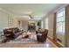 Inviting living room with hardwood floors, a brick fireplace, and plenty of natural light at 1744 Cum Laude Way, Lawrenceville, GA 30044
