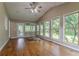 Bright sun room with vaulted ceiling, hardwood floors, and many windows with backyard views at 1744 Cum Laude Way, Lawrenceville, GA 30044