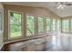 Bright sun room with vaulted ceiling, hardwood floors, and many windows with backyard views at 1744 Cum Laude Way, Lawrenceville, GA 30044