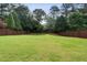 Expansive, well-manicured backyard enclosed by a wooden privacy fence and mature trees, providing a serene outdoor space at 1860 Leighton Ln, Marietta, GA 30062