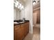 Cozy bathroom featuring a dark vanity with granite top and a shower with tiled walls at 1860 Leighton Ln, Marietta, GA 30062