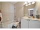 A bathroom showcasing a shower-tub combo, a toilet, and a sink vanity with white cabinetry at 1860 Leighton Ln, Marietta, GA 30062