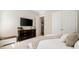Cozy bedroom features a large dresser with flat screen television and spacious closets at 1860 Leighton Ln, Marietta, GA 30062