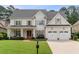 Beautiful two-story home with a manicured lawn, attached two-car garage, and inviting front porch with brickwork at 1860 Leighton Ln, Marietta, GA 30062