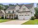 Charming two-story home with a well-kept lawn, an attached two-car garage, and classic architectural details at 1860 Leighton Ln, Marietta, GA 30062