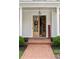 Welcoming front entrance features a double-door entry with brick steps and decorative plants, adding charm and curb appeal at 1860 Leighton Ln, Marietta, GA 30062