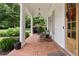 Inviting front porch with brick flooring, comfortable seating, and classic architectural details, perfect for relaxation at 1860 Leighton Ln, Marietta, GA 30062