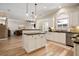 Open-concept kitchen flowing to the living room, featuring white cabinets, stainless appliances, and dark countertops at 1860 Leighton Ln, Marietta, GA 30062