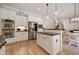 Well-lit kitchen with stainless steel appliances, white cabinets, island, and an open layout to the dining area at 1860 Leighton Ln, Marietta, GA 30062