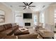 Inviting living room with a stone fireplace, mounted TV, comfortable seating, and a ceiling fan at 1860 Leighton Ln, Marietta, GA 30062