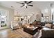Spacious living room with hardwood floors, fireplace, and a view of the kitchen and staircase at 1860 Leighton Ln, Marietta, GA 30062