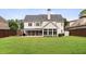 Rear exterior view of the home featuring a large backyard, screened porch, sunroom, and two-story design at 1860 Leighton Ln, Marietta, GA 30062