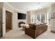 Inviting sitting area with a comfortable couch, large TV, and natural light from many windows at 1860 Leighton Ln, Marietta, GA 30062