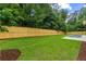 A manicured backyard with a lush lawn, wood fence, and a small pool at 16 Bonnie Ln, Atlanta, GA 30328