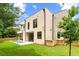 A modern home's backyard with a small pool, lush lawn and wood fence at 16 Bonnie Ln, Atlanta, GA 30328
