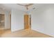 Bright bedroom featuring light wood floors, white walls, ceiling fan and doors to other rooms at 16 Bonnie Ln, Atlanta, GA 30328