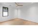 Bright bedroom features light wood floors, white walls, ceiling fan and a black framed window at 16 Bonnie Ln, Atlanta, GA 30328